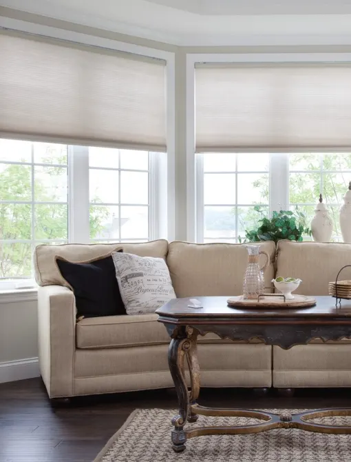 Automated roller blinds filtering daylight into a lounge