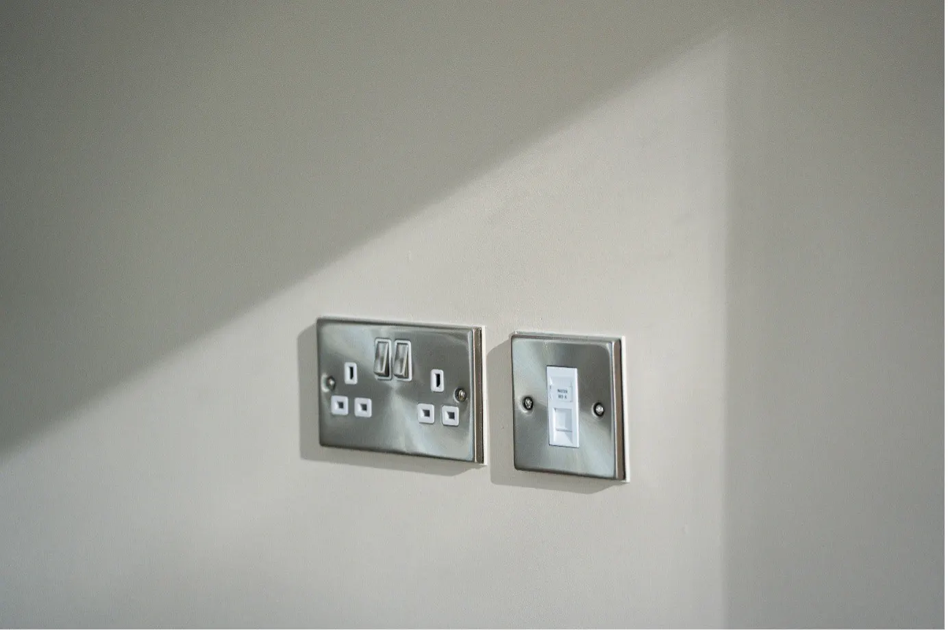 Brushed steel sockets and data plate fitted during a rewire