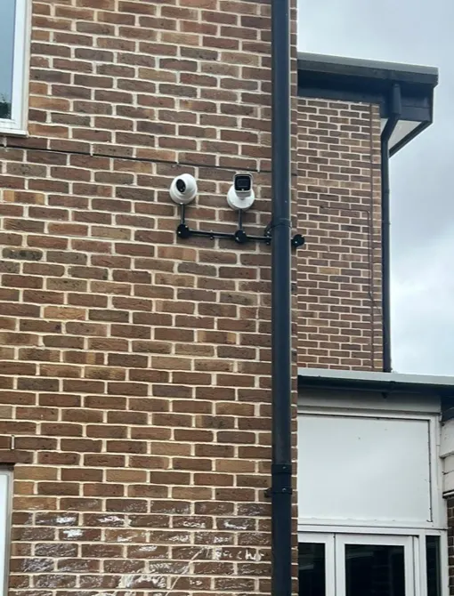 CCTV cameras integrated with an alarm system on a brick house